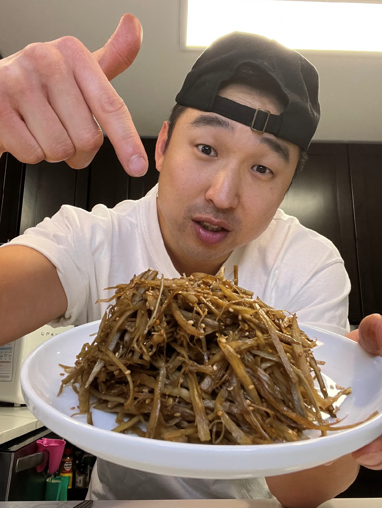 Chef Chris Cho making soy braised burdock root