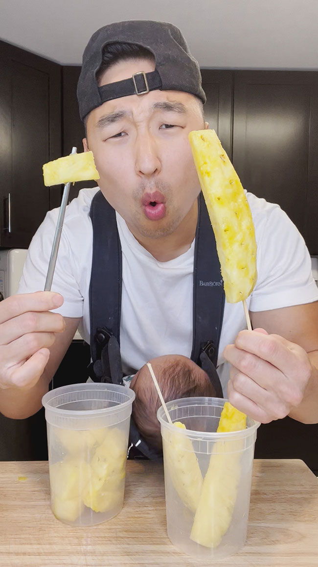 Chef Chris Cho cutting pineapple 