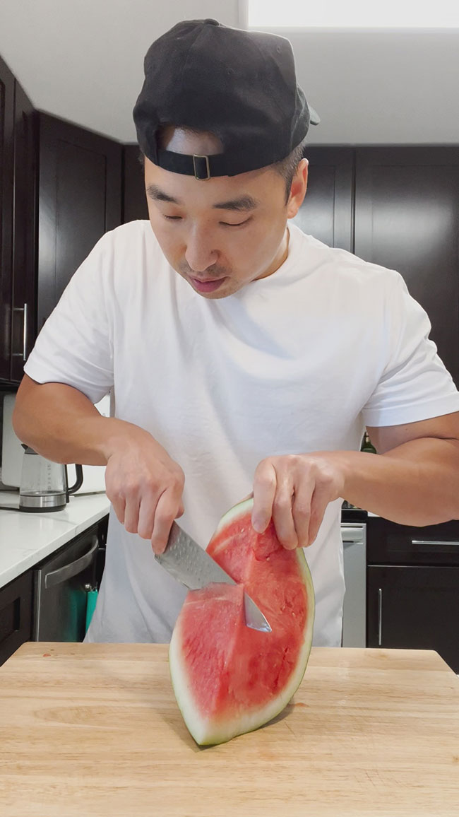 Hold up and tilt watermelon, then slice from the middle