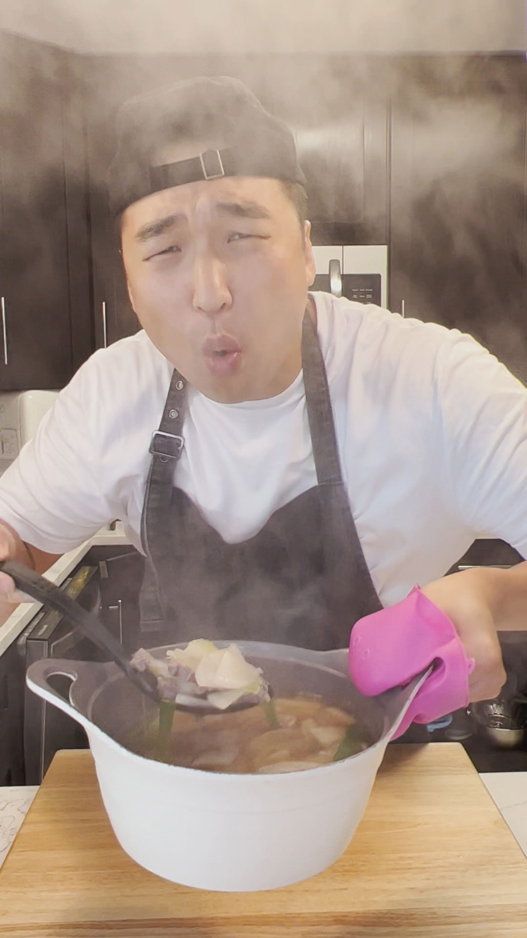 Chef Chris Cho holding a pot of Korean Beef and Radish Soup 