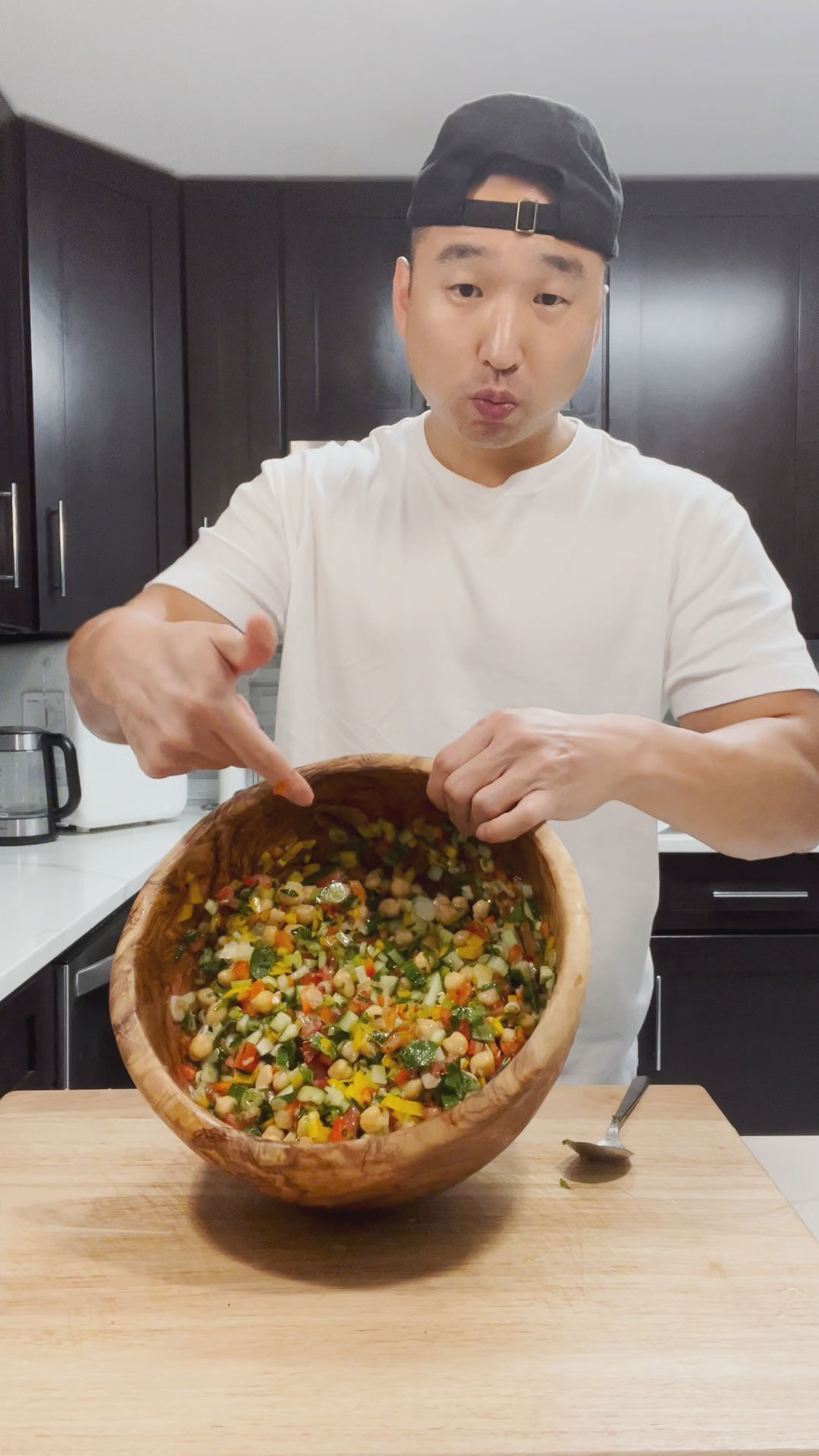 Chef Chris Cho holding a bowl of Balela Salad 
