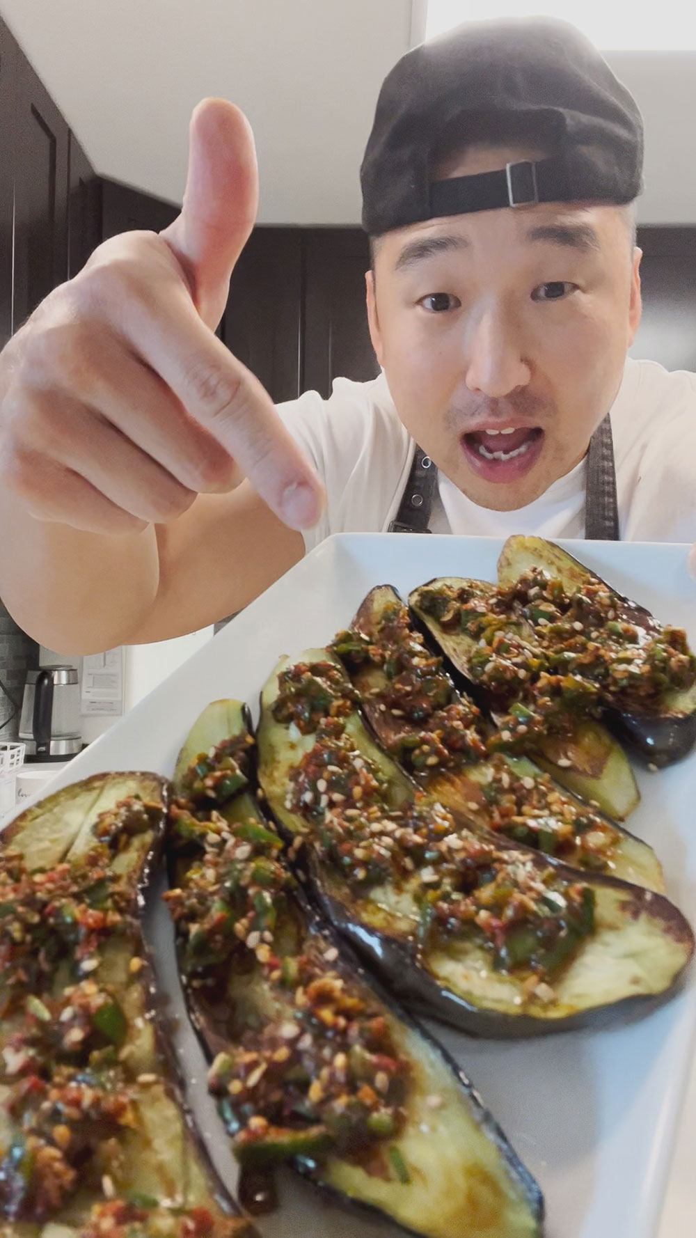Chef Chris Cho with fried eggplant with pepper and chive sauce 