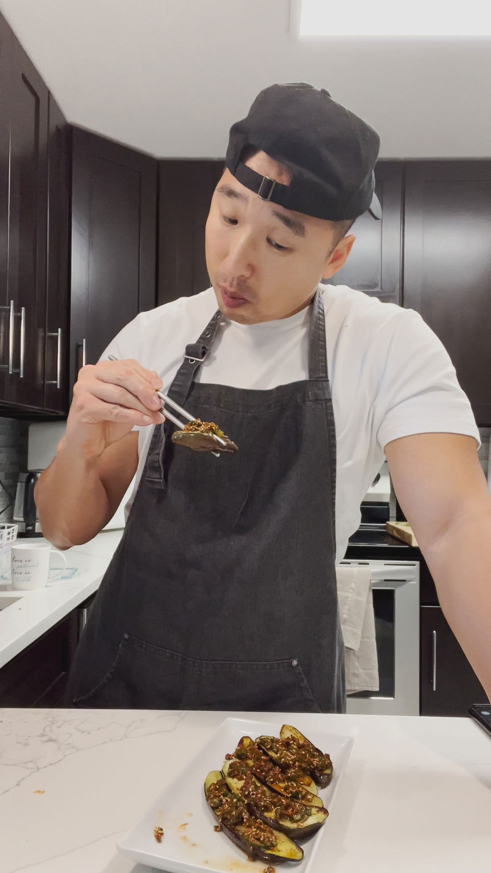 Chef Chris Cho trying out fried eggplant with spicy sauce 