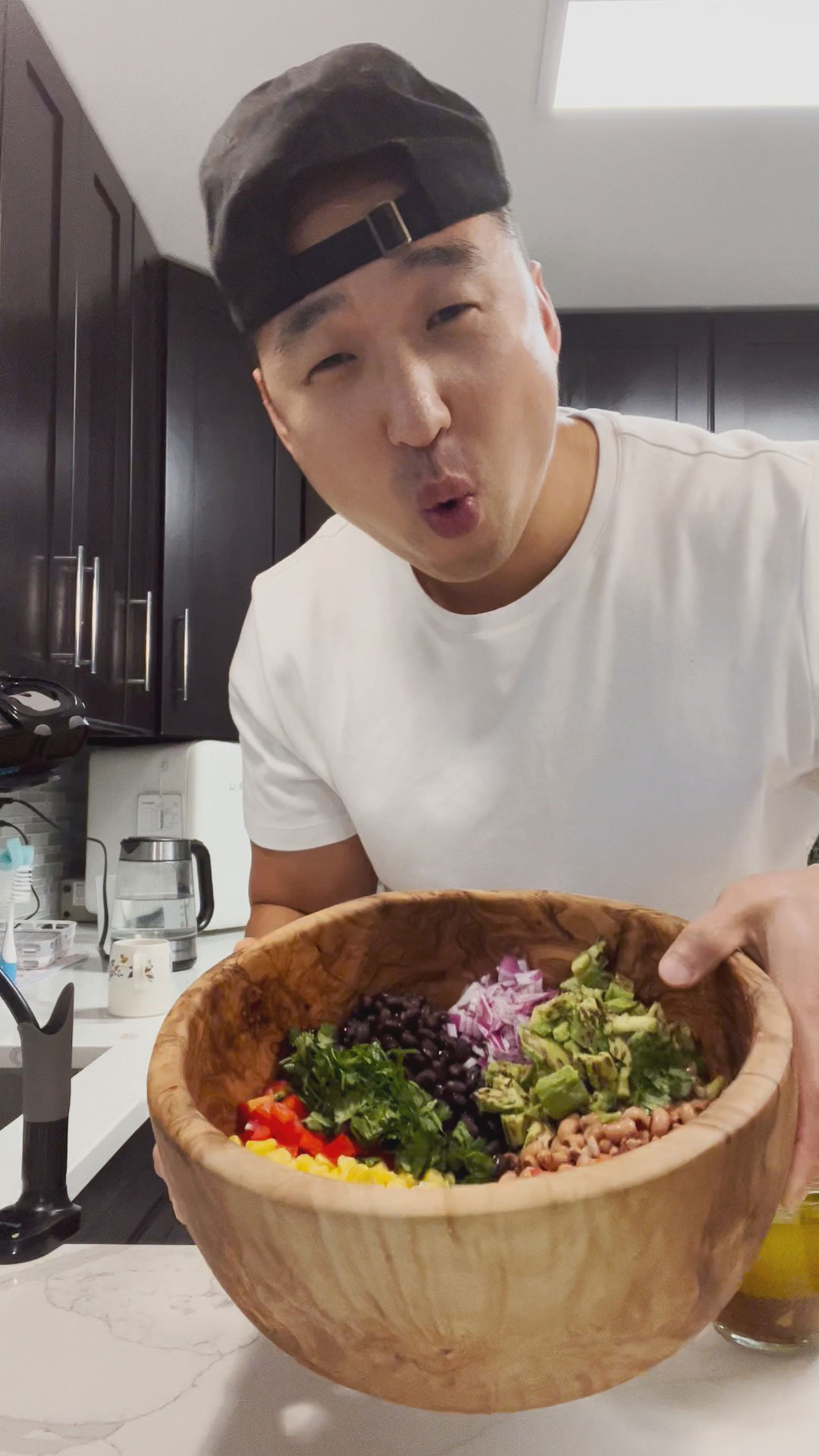 Chef Chris Cho with cowboy caviar in a huge wooden salad bowl 