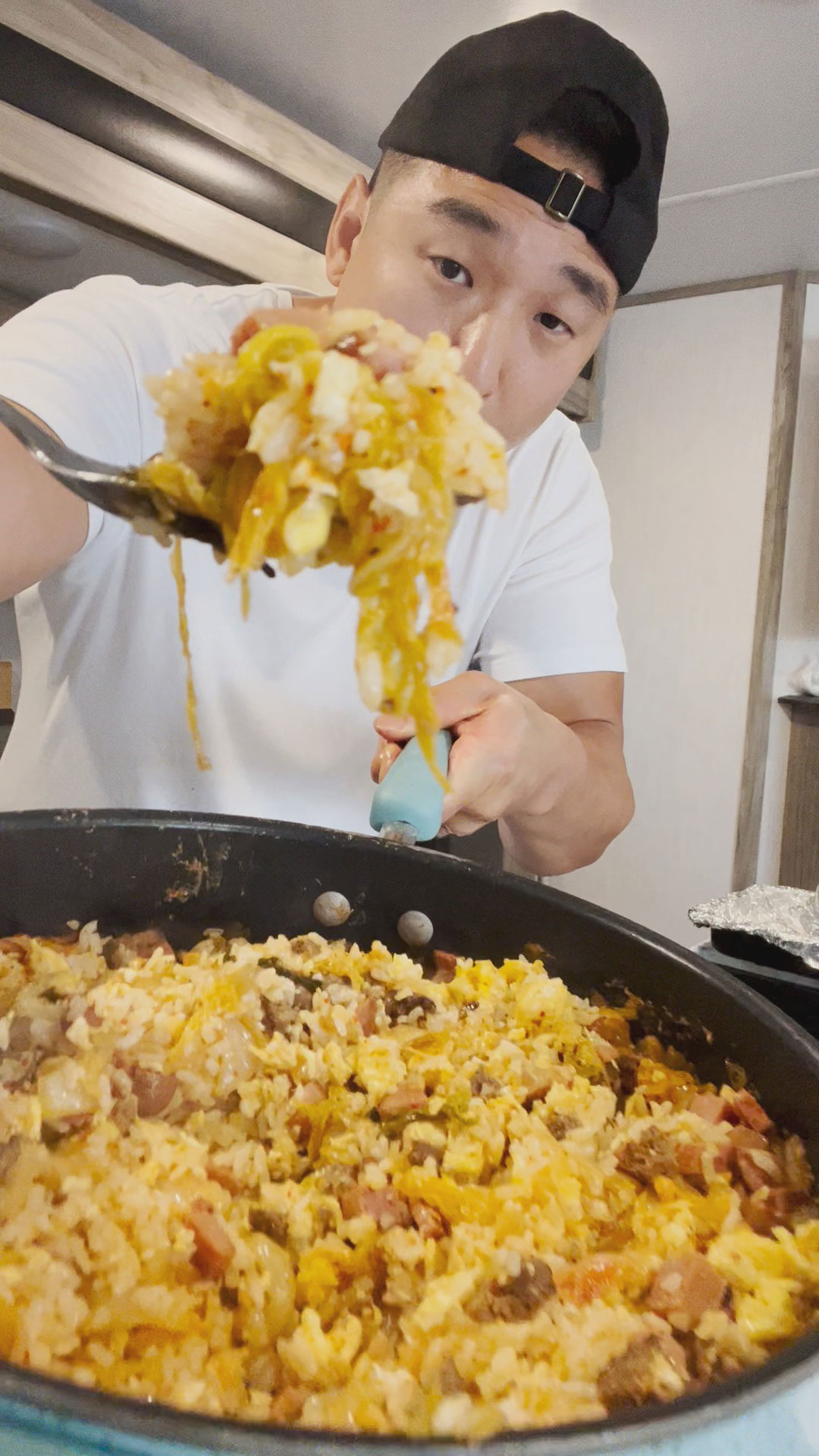 Chef Chris Cho holding a pan with leftover fried rice