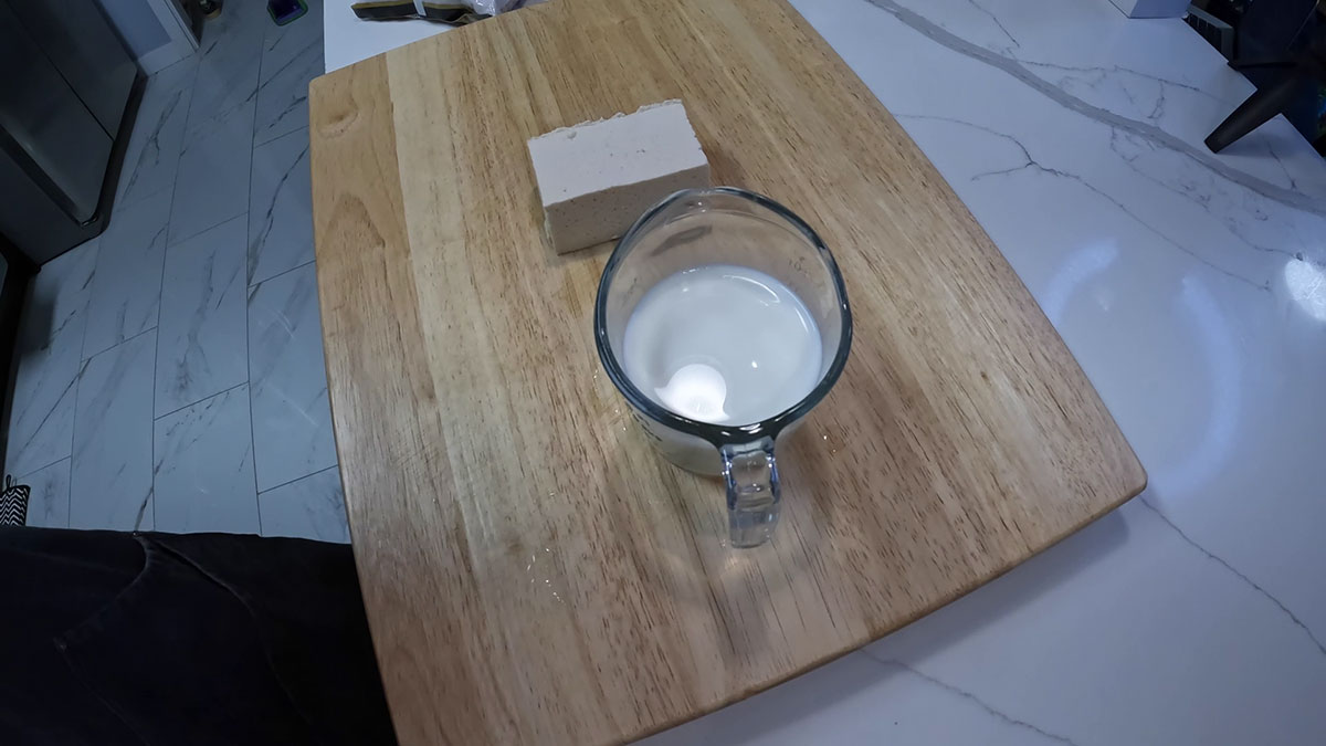 A block of tofu and a cup of milk 