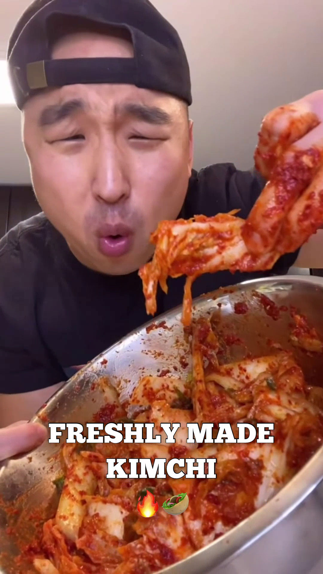 Chef Chris Cho holding a bowl of kimchi 