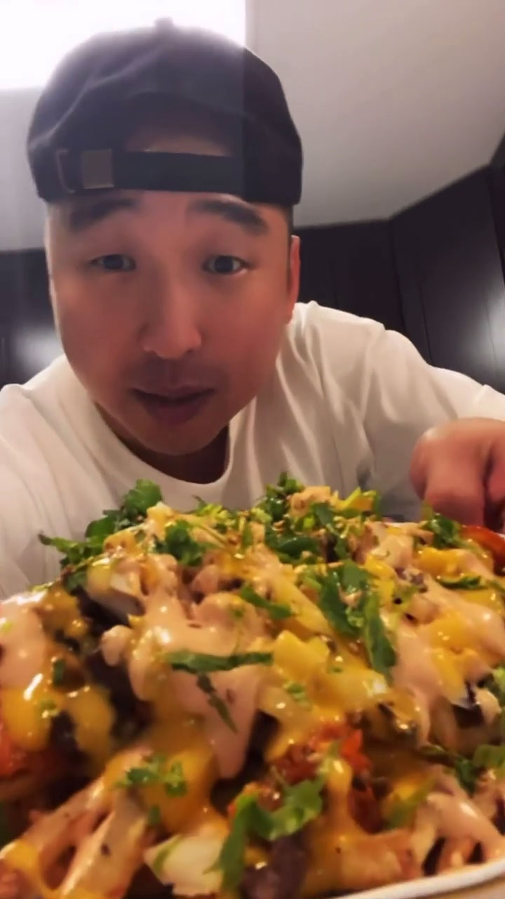 Chef Chris Cho holding a plate of Kimchi Fries
