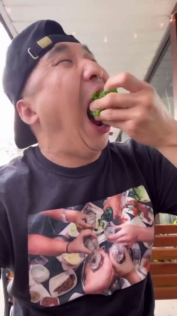 Chef Chris Cho eating ssam in one bite 