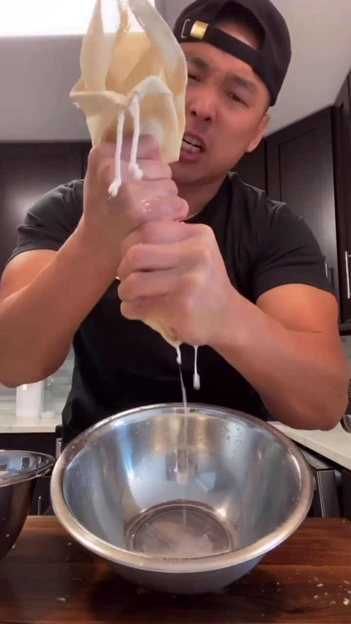 Chef Chris Cho squeezing water out from the chopped vegetables 