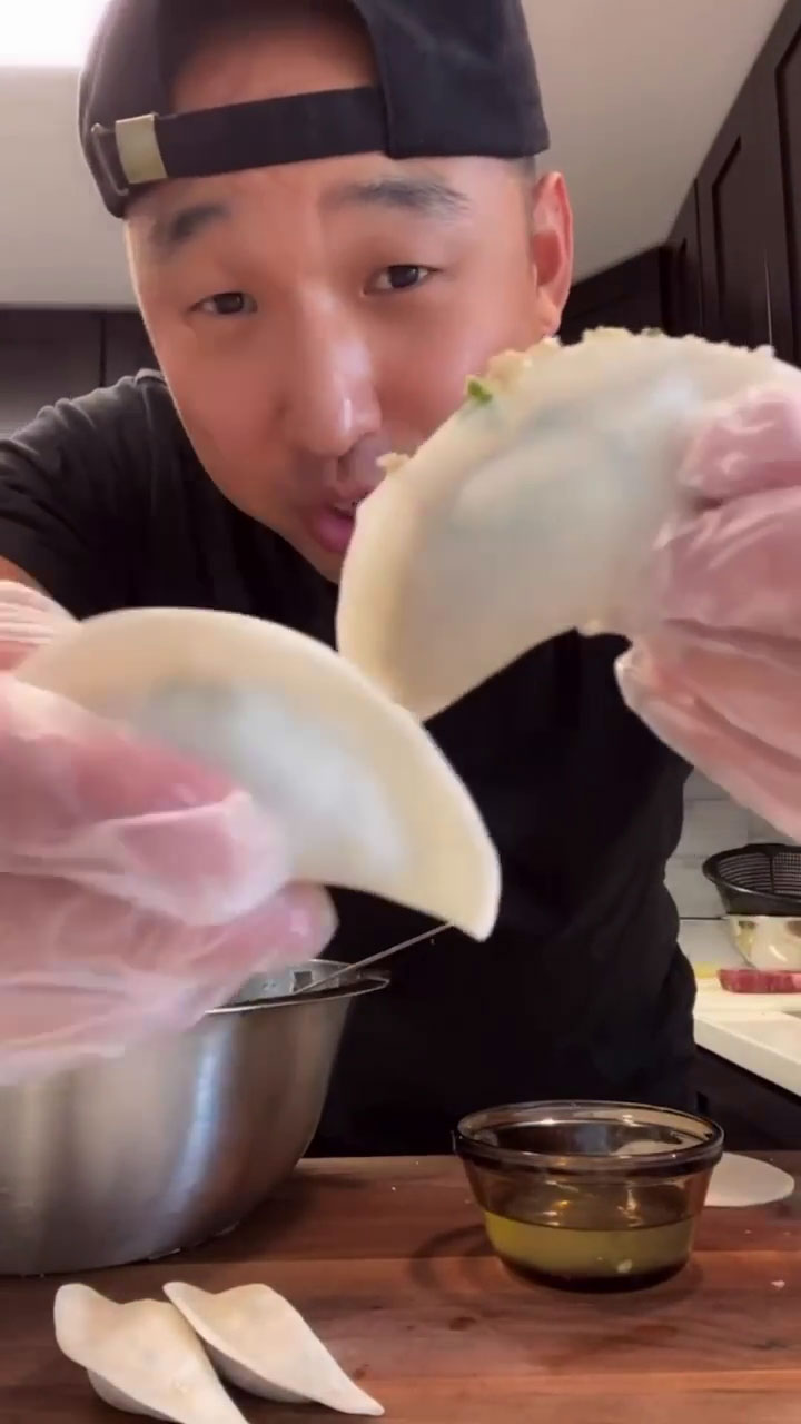 Chef Chris Cho showing the comparison of perfectly filled and overfilled dumplings 