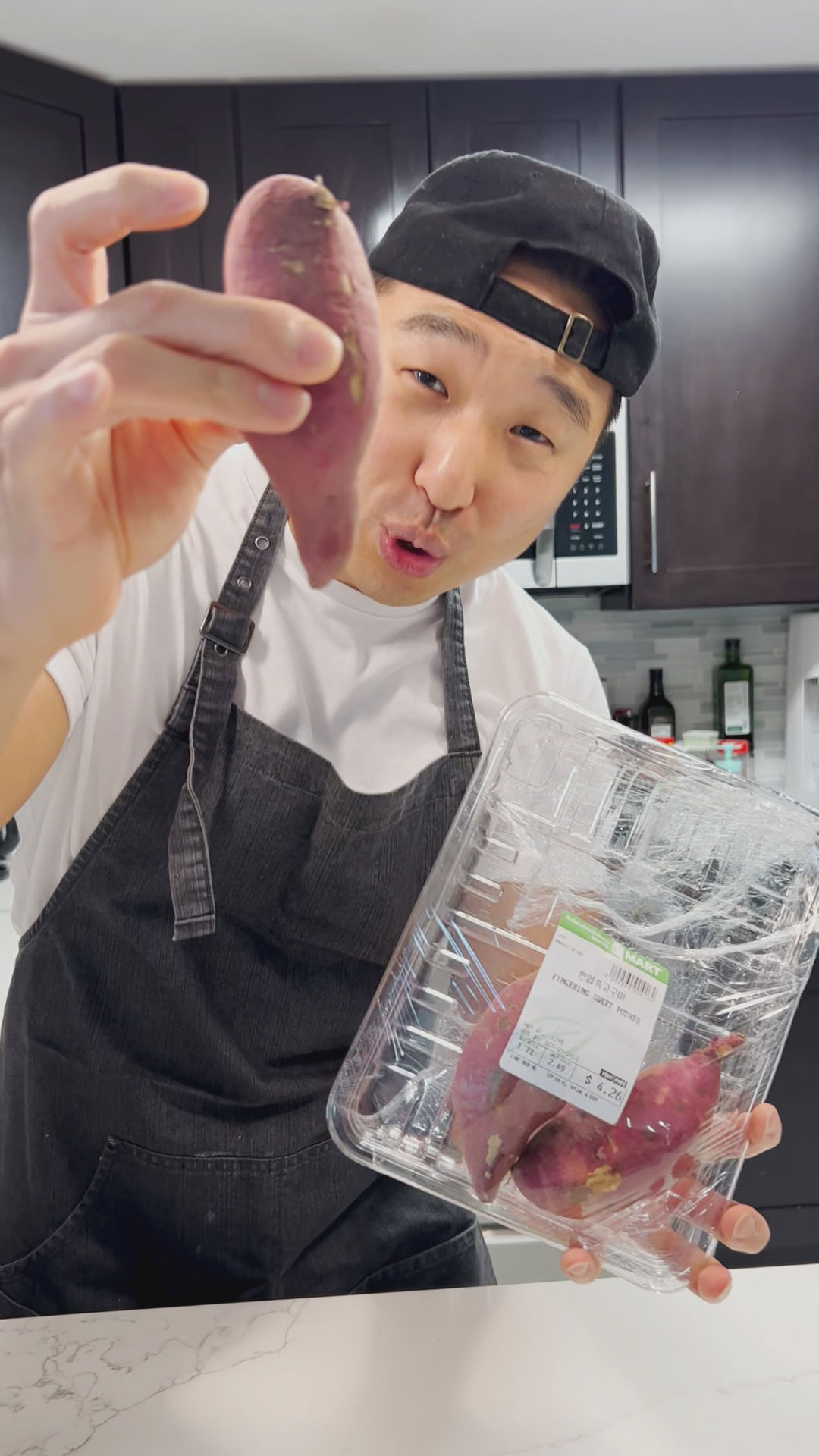 Chef Chris Cho holding Korean Sweet Potatoes 