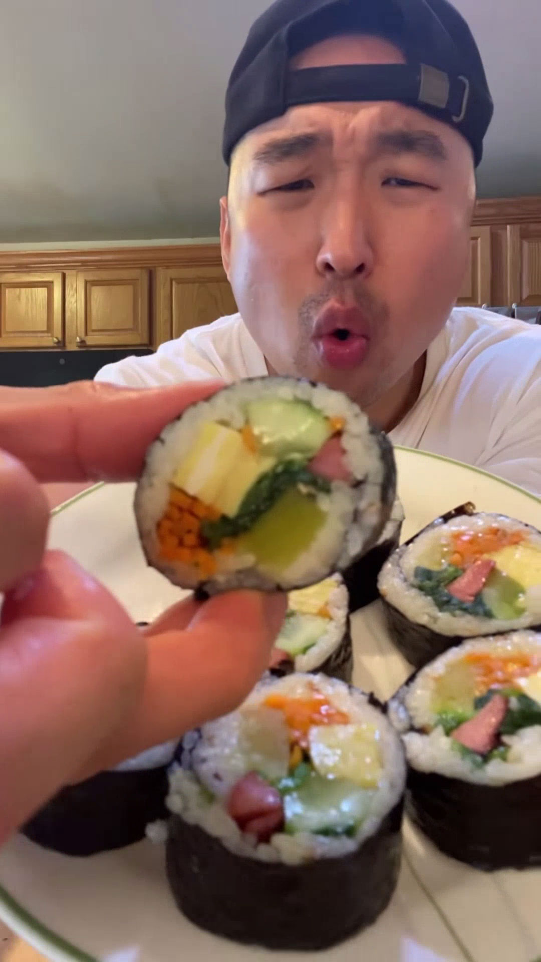 Chef Chris Cho holding a kimbap 