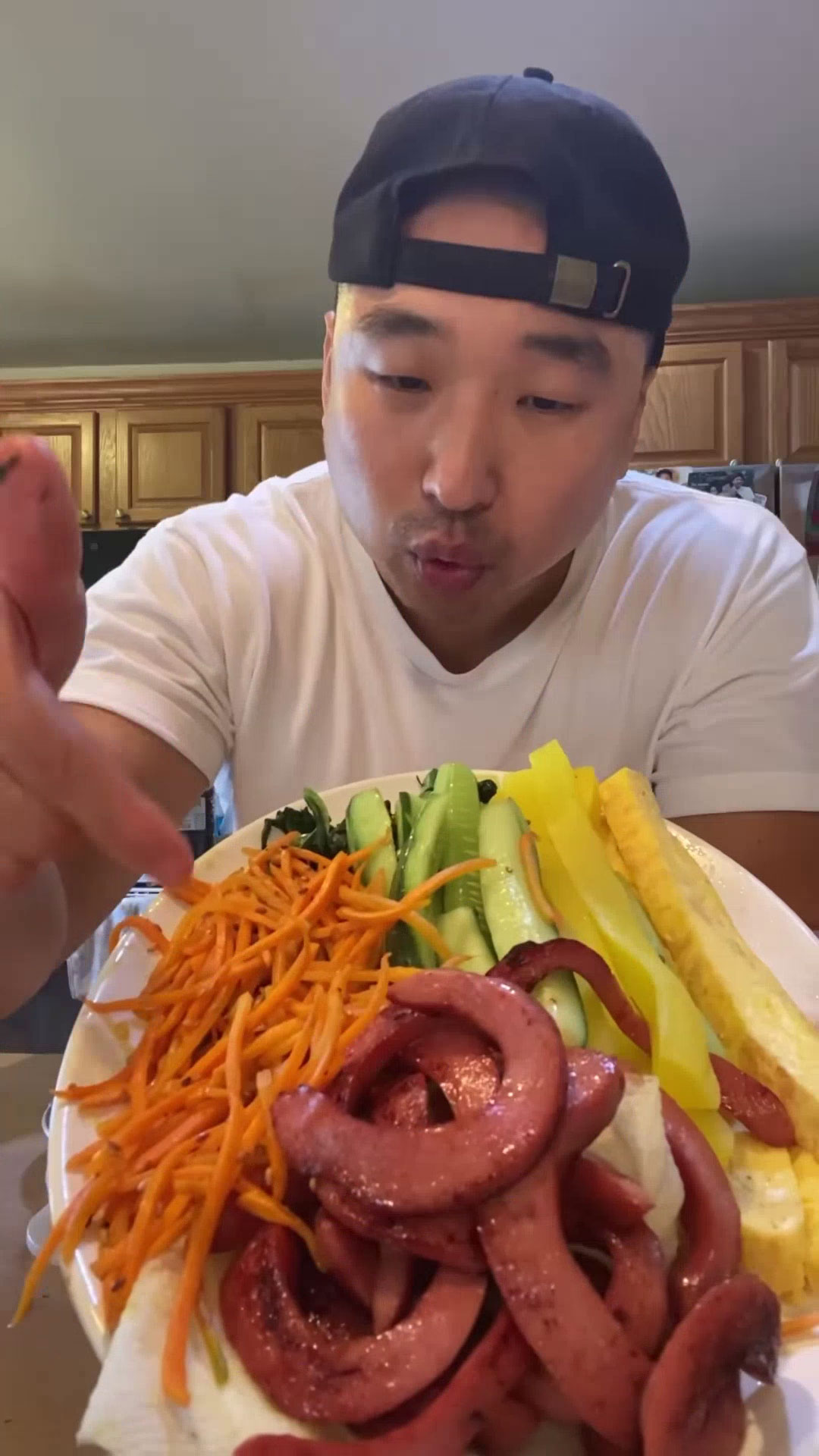 Chef Chris Cho holding a plate of kimbap ingredients 