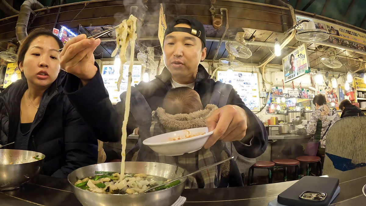 Chef Chris Cho enjoying handcut noodles in Namdaemun Kalguksu Alley 