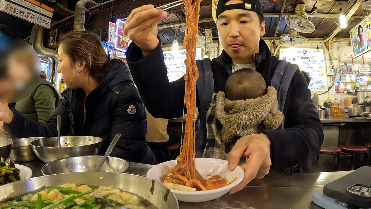Chef Chris Cho enjoying spicy cold noodles in Namdaemun Kalguksu Alley 
