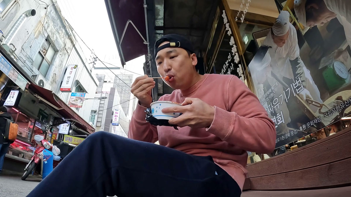 Chef Chris Cho enjoying tteokbokki 