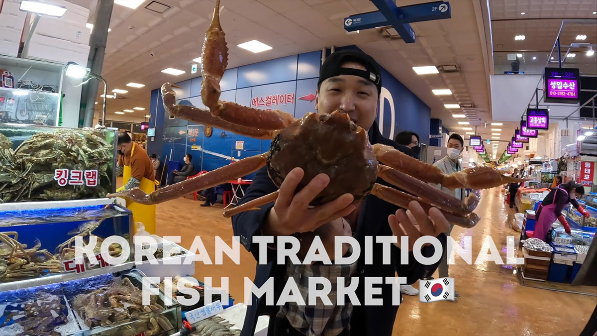 Chef Chris Cho holding a king crab in Noryangjin Fish Market 