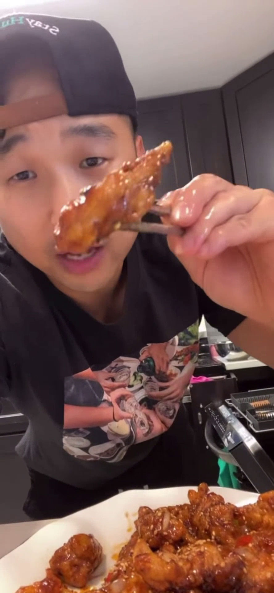 Chef Chris Cho holding spicy garlic fried chicken 