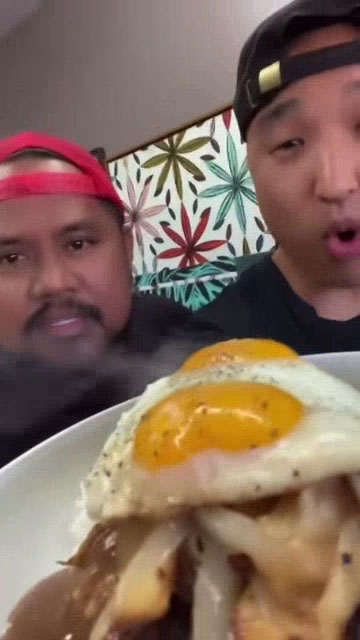 Chef Sheldon Simeon and Chef Chris Cho holding a plate of Loco Moco 