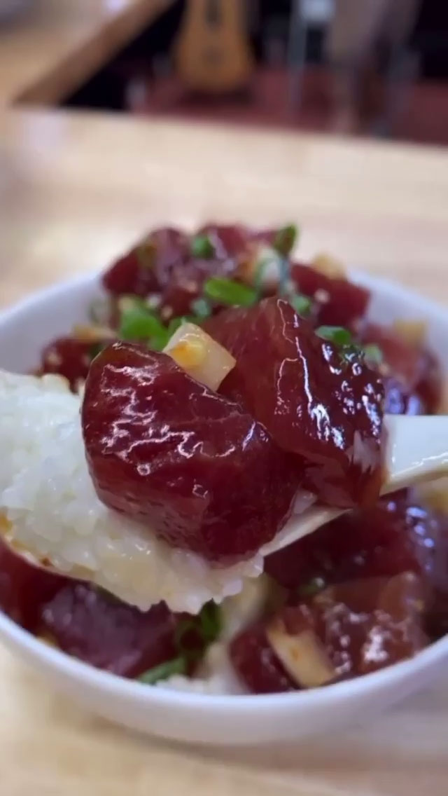 A bite of ahi poke with rice 