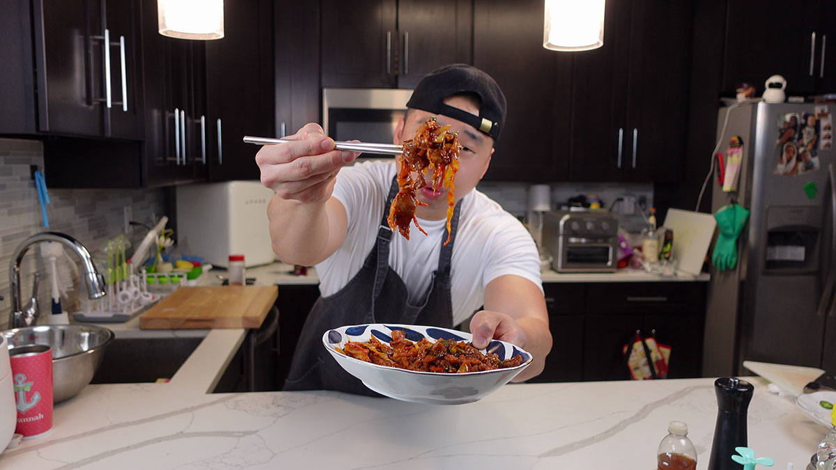 Chef Chris Cho with a spicy pork stir fry 