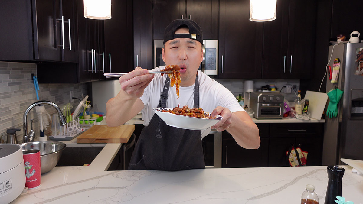 Chef Chris Cho with a plate of jeyuk bokkeum 