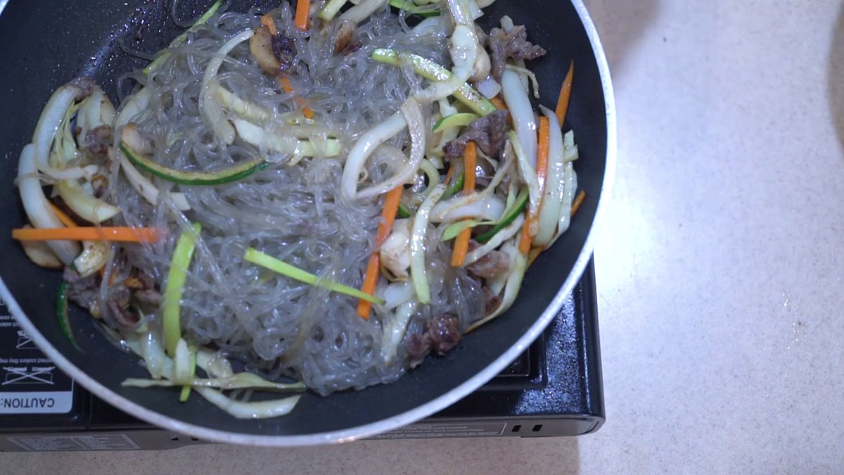 Add the noodles to the stir fried vegetables 