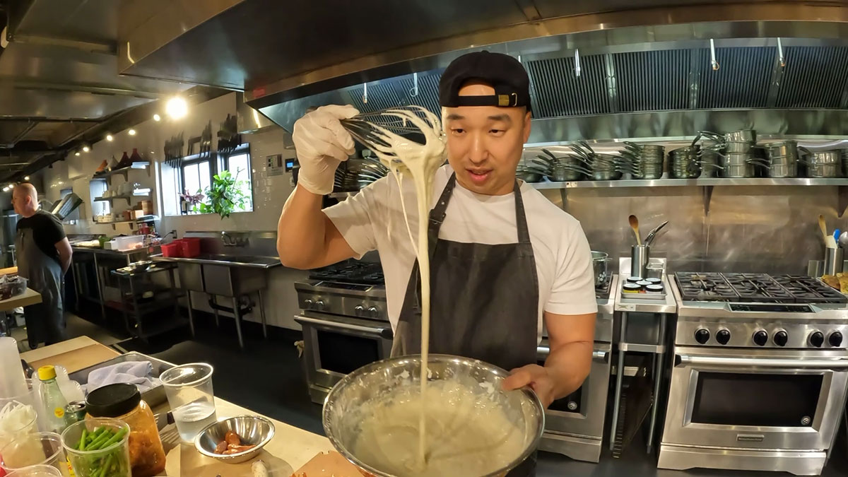 Chef Chris Cho showing the correct consistency of kimchi pancake batter 