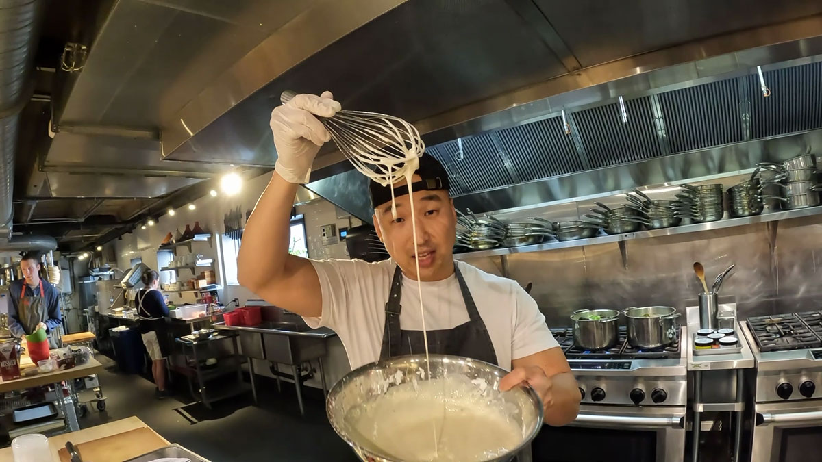 Chef Chris Cho showing a loose kimchi pancake batter 