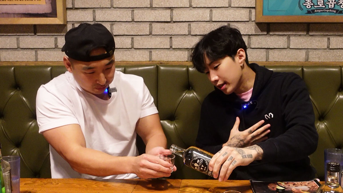 Jay Park pouring Won Soju for Chef Chris Cho