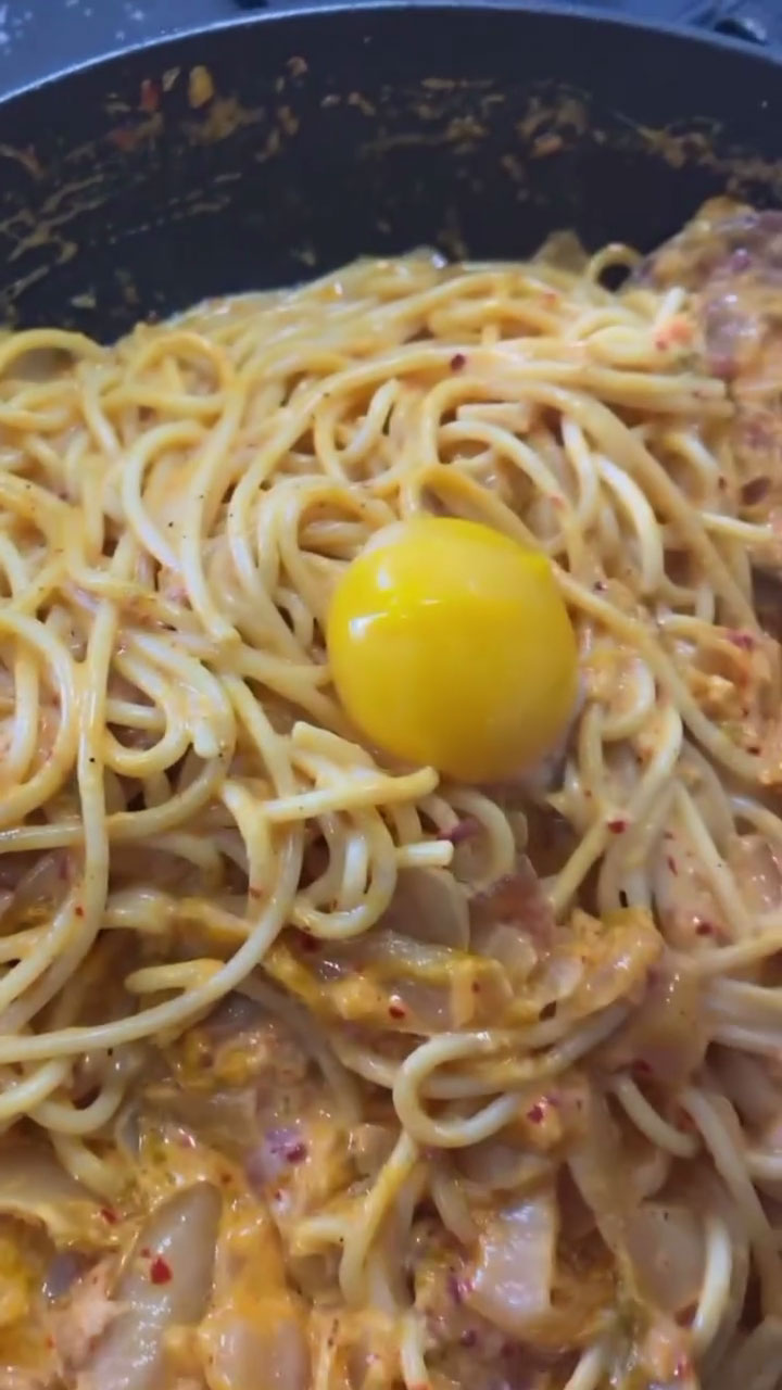 Kimchi Pasta with egg yolk on top 