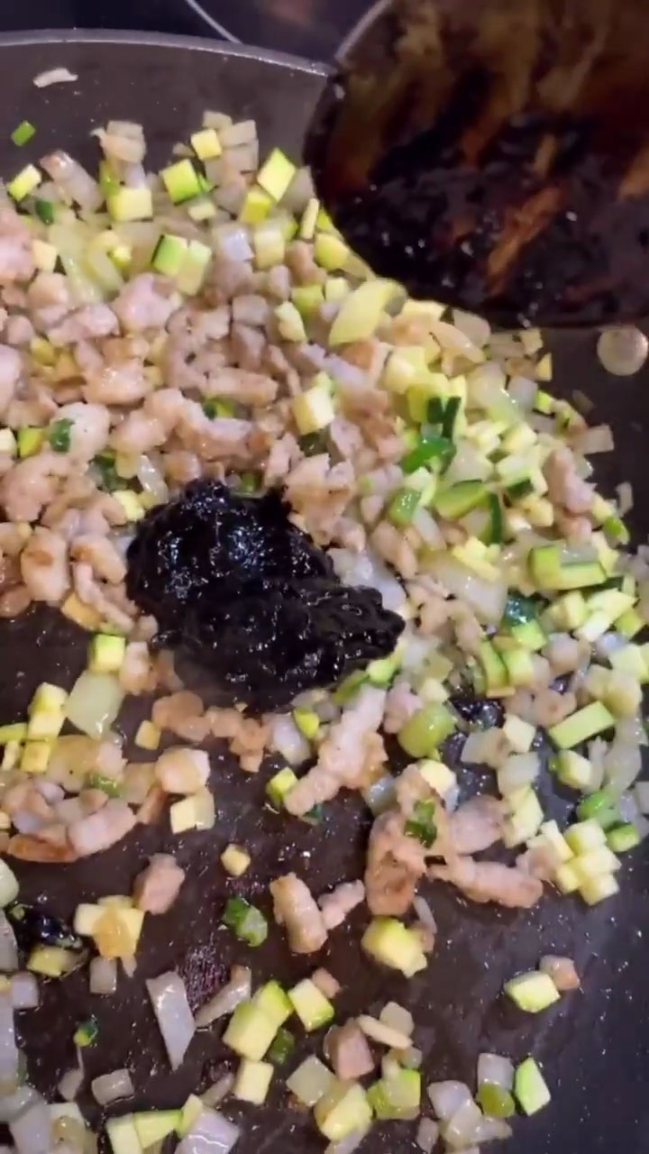 Add the pork, vegetables, and black bean paste