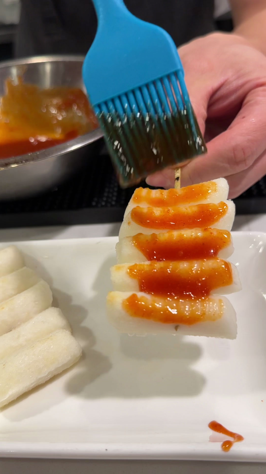 Brush the sauce into the rice cake skewers