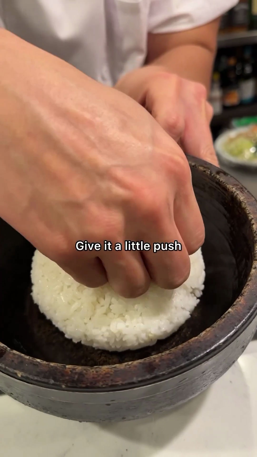 Push rice to the edges of the stone pot