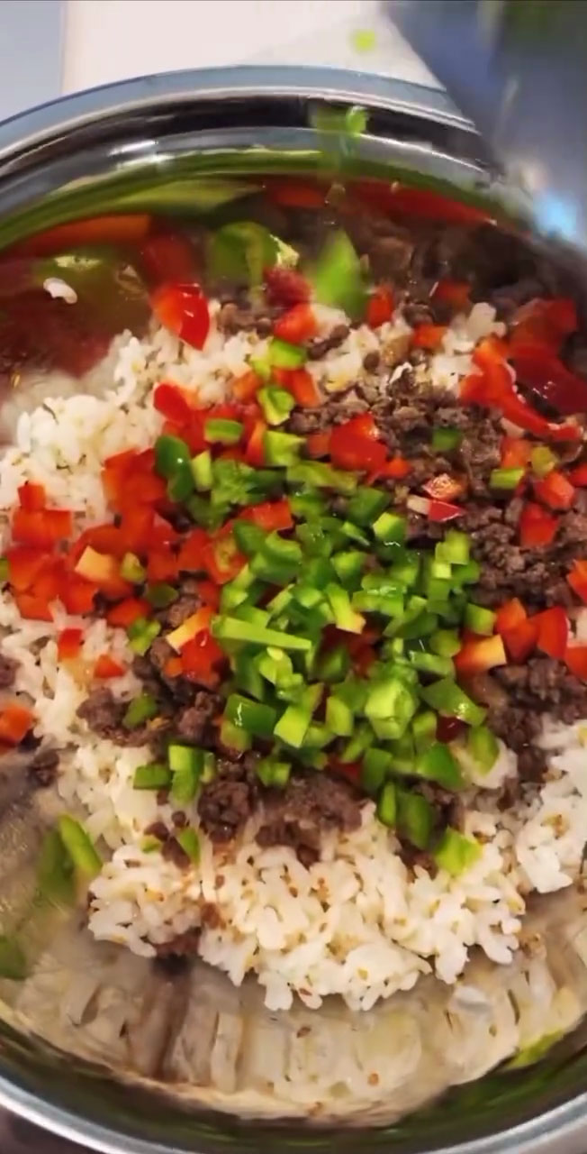 Add the vegetables to the seasoned ground beef and rice 