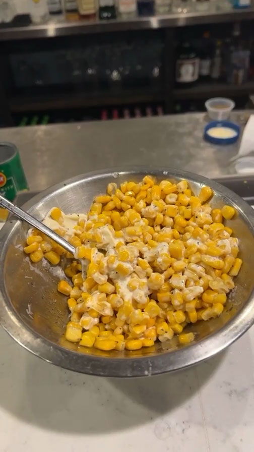 Season the corn with mayo, butter, sugar, and black pepper 