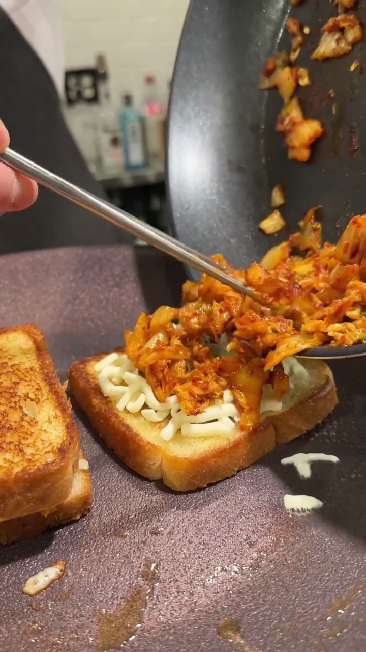 Place the kimchi on top of the cheese 