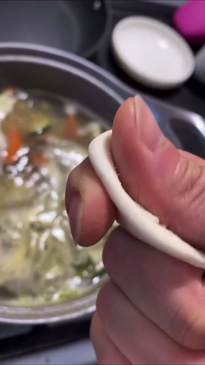 Stretch sujebi dough thin with index finger and thumb