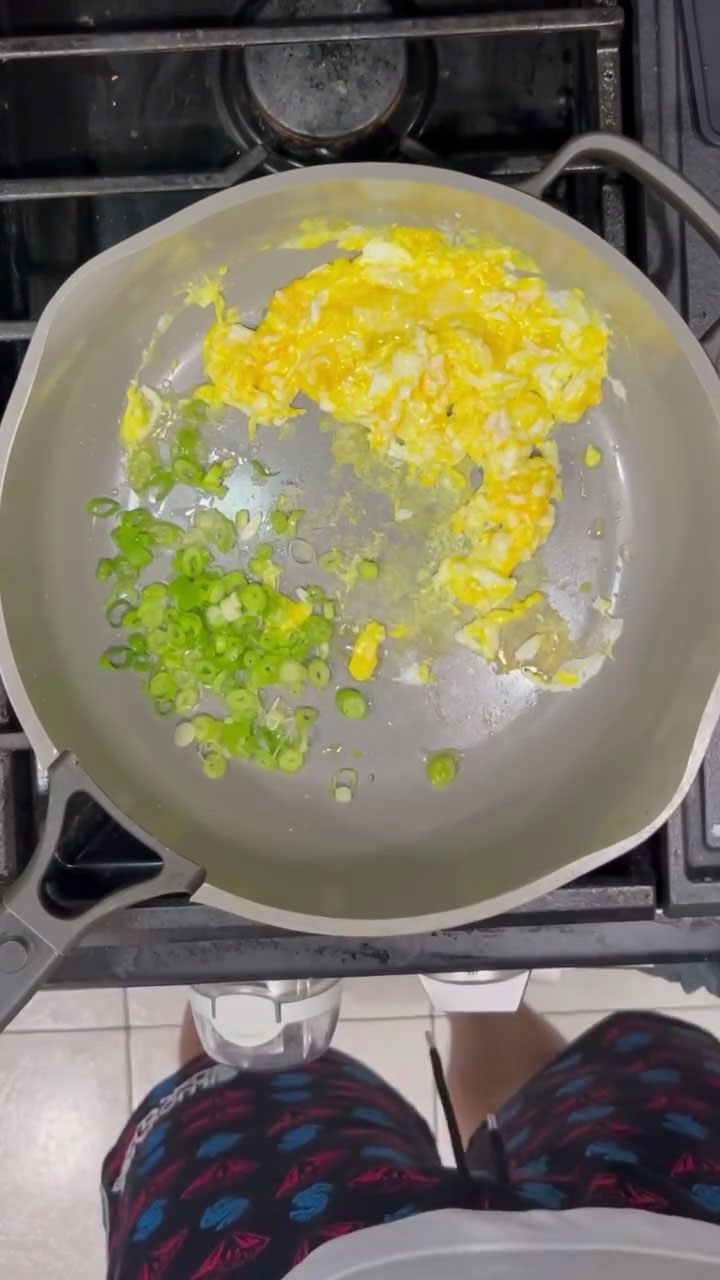 Scramble the eggs and saute the scallions 