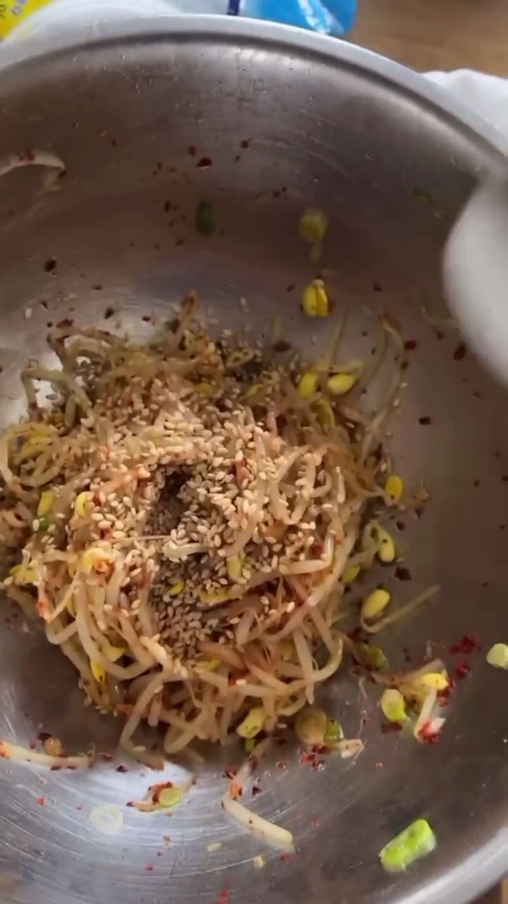 Garnish the beansprouts with sesame seeds