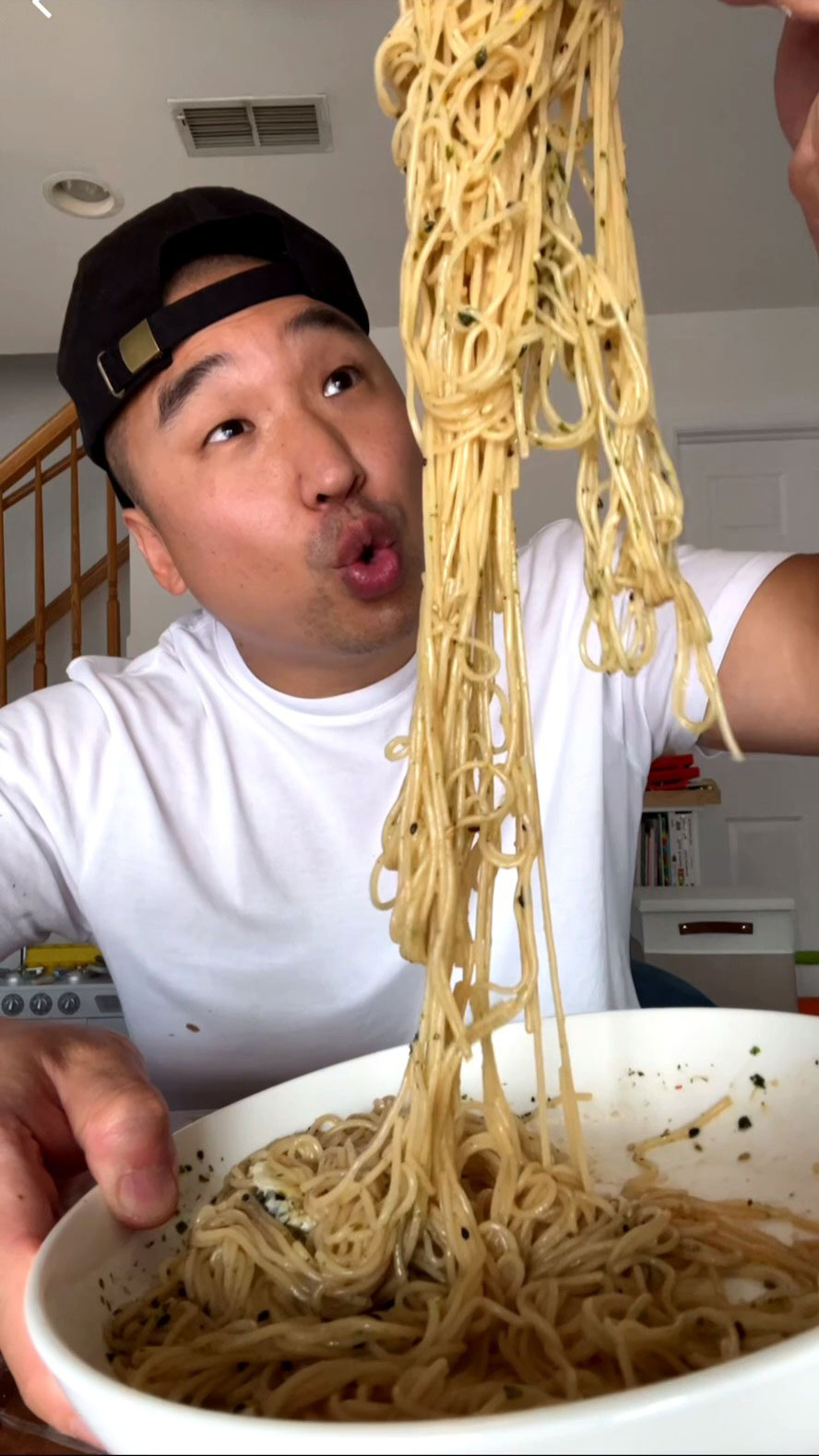 Chef Chris Cho enjoying soy garlic noodles 
