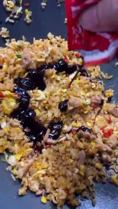 Adding the buldak sauce to the fried rice