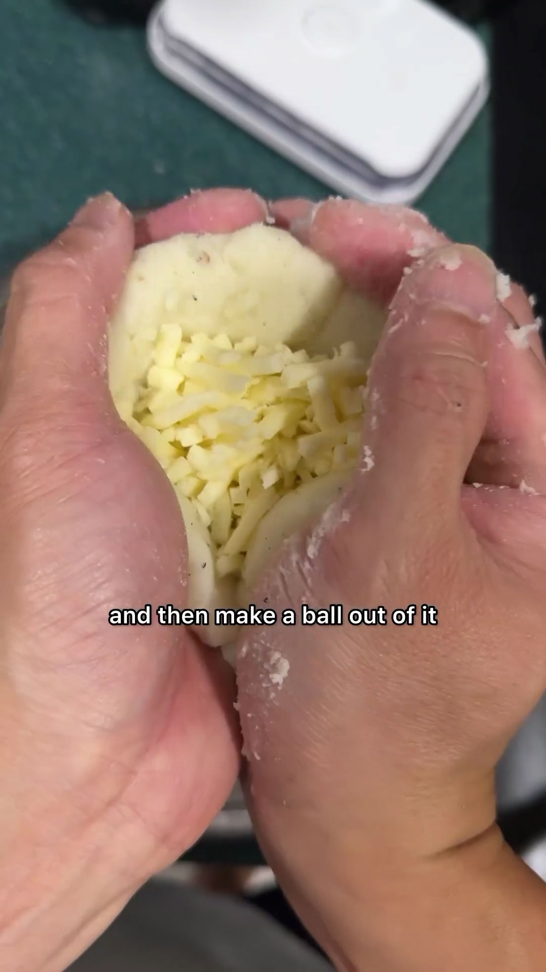 Tuck in the cheese in the middle of the potato 