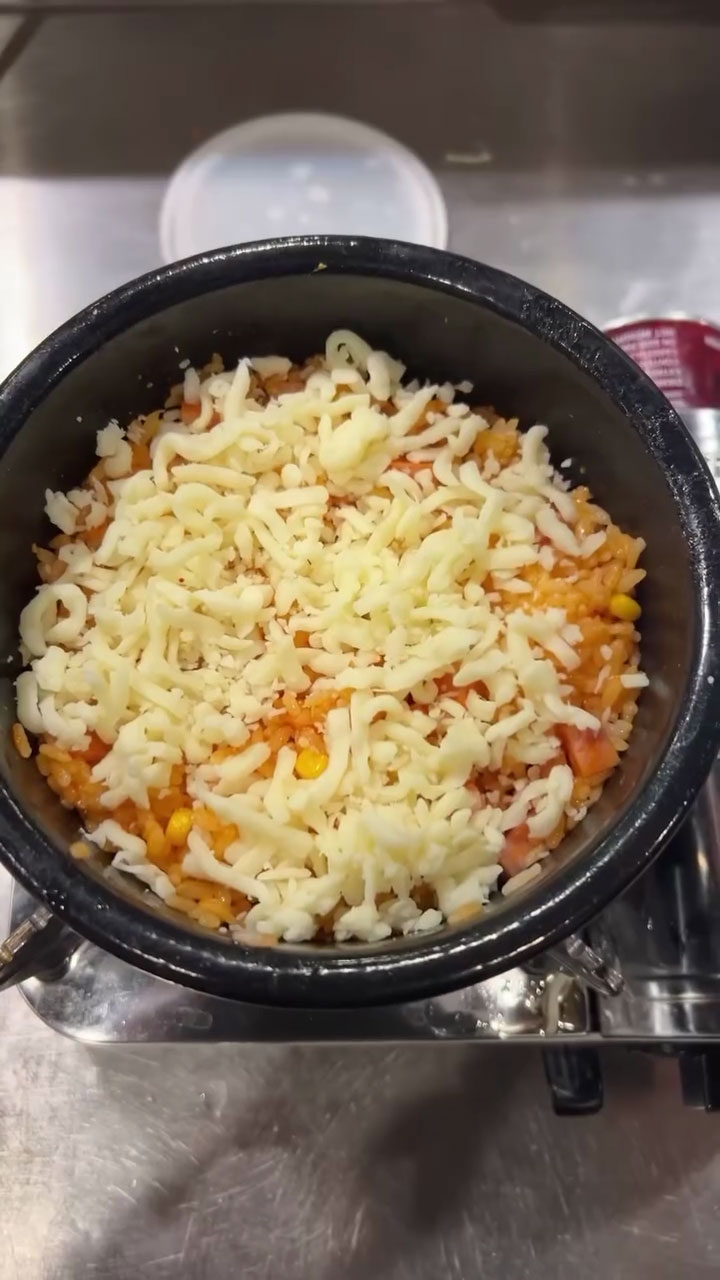 Add the cheese to cheesy spam rice 