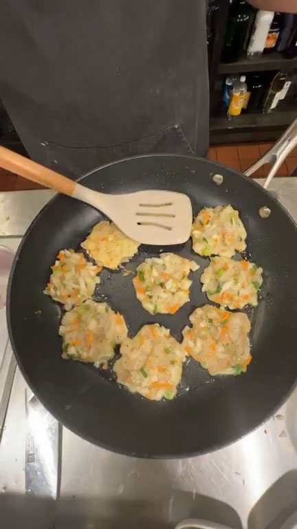 Place shrimp pancake batter in the heated pan one tablespoon at a time 