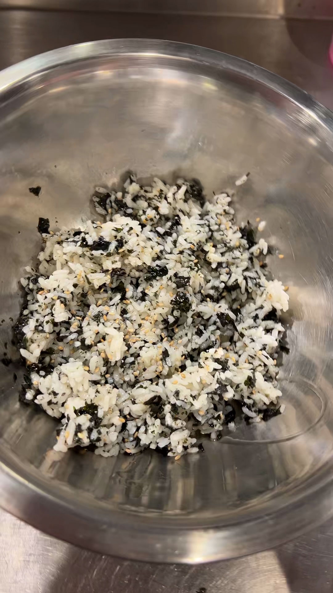 Season the rice with salt, pepper, sesame oil, sesame seeds, and seaweed paper