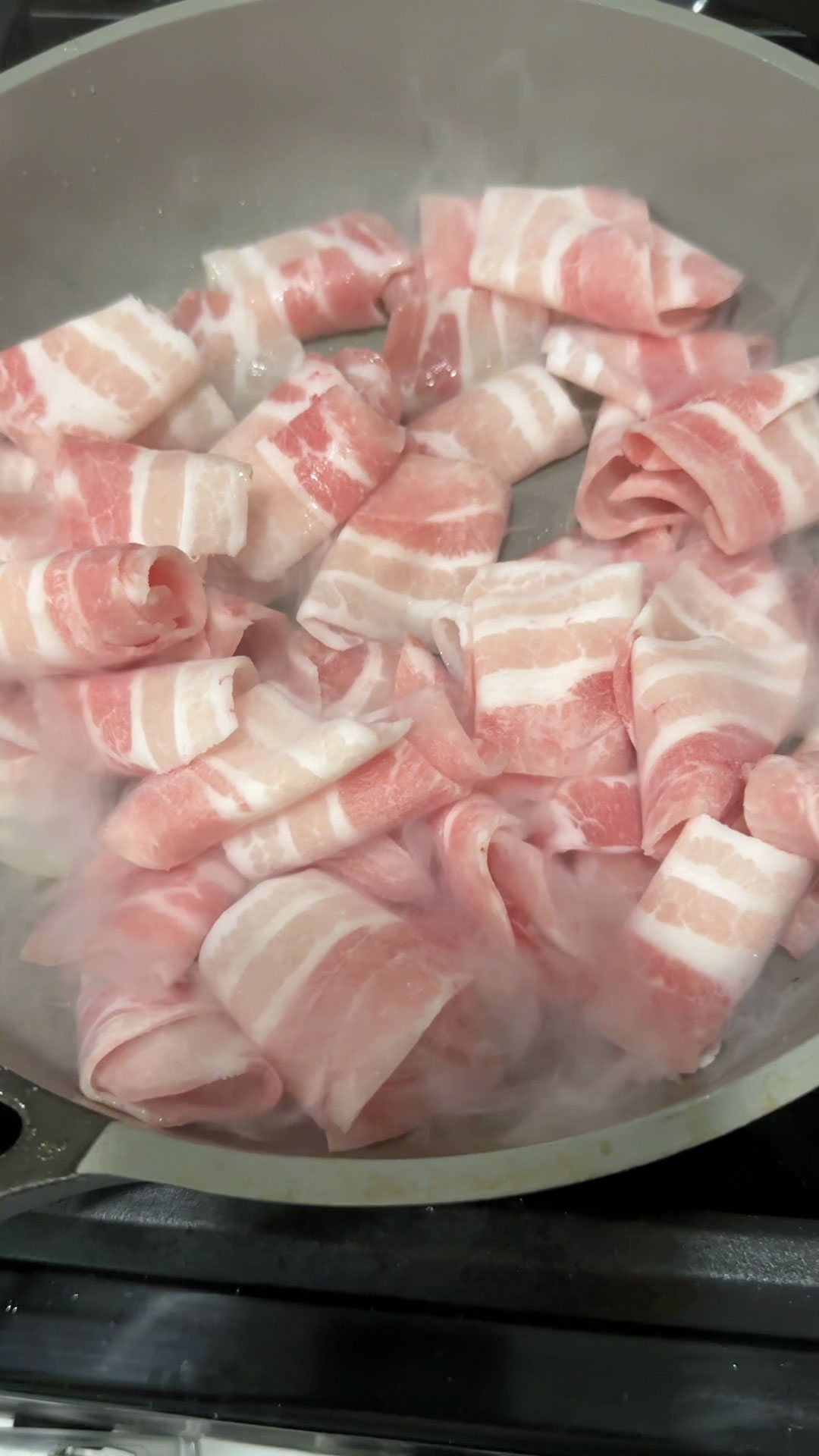 Place the pork belly strips in the pan