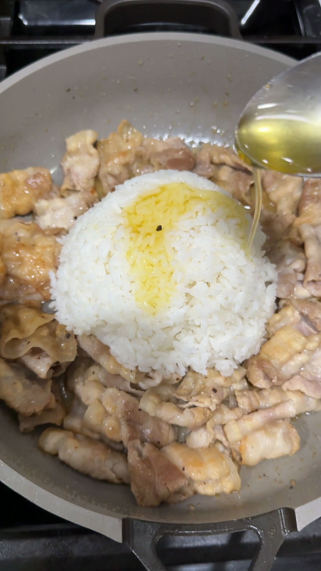 Add rice to the pan and season it with sesame oil and oyster sauce 