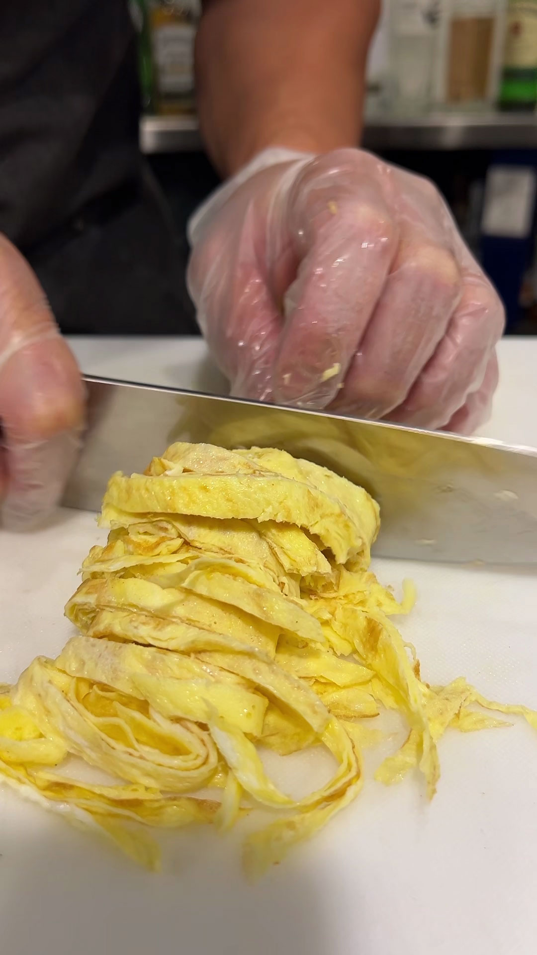 Slicing the piled up egg sheets